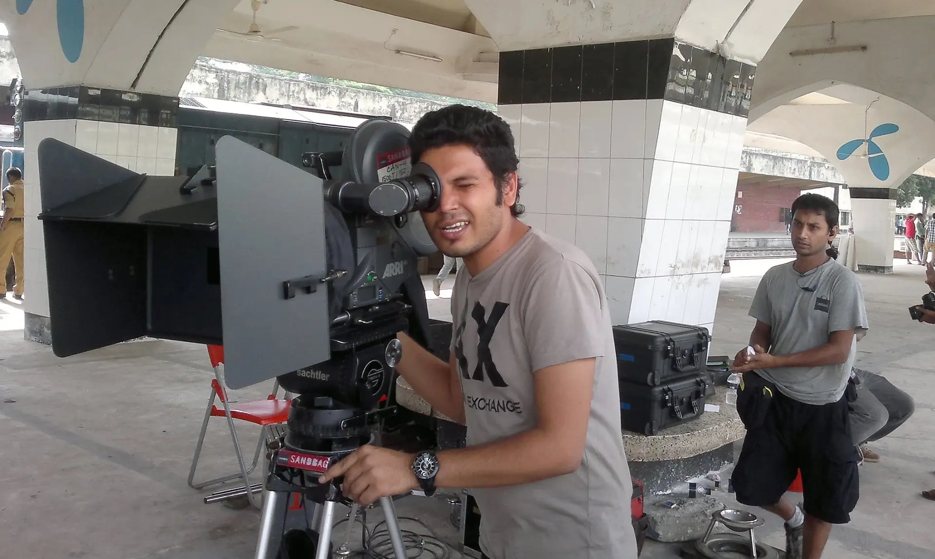 Deloar Hossain filming with professional camera on location
